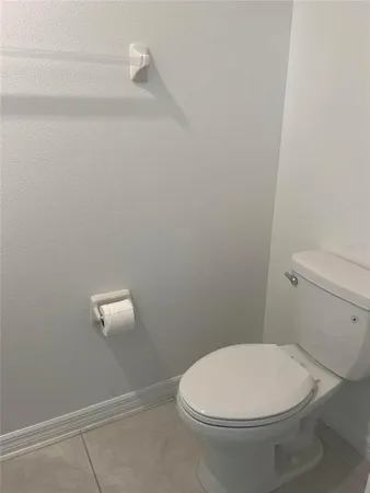 a white toilet sitting next to a shower