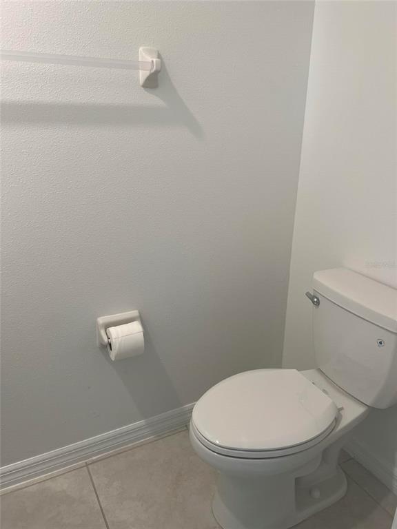 14442 Editors Note Street Ruskin, FL 33573 - Photo 21 of 31 a white toilet sitting next to a shower