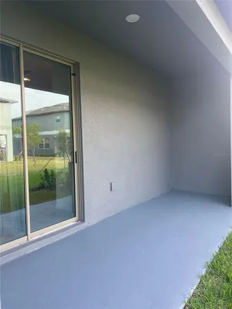 a view of an empty room with glass door