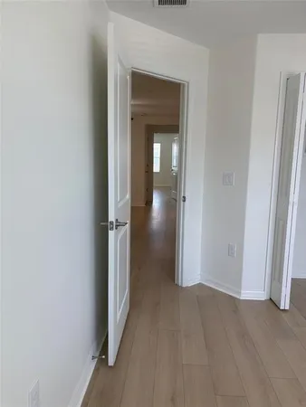 a view of a hallway with wooden floor