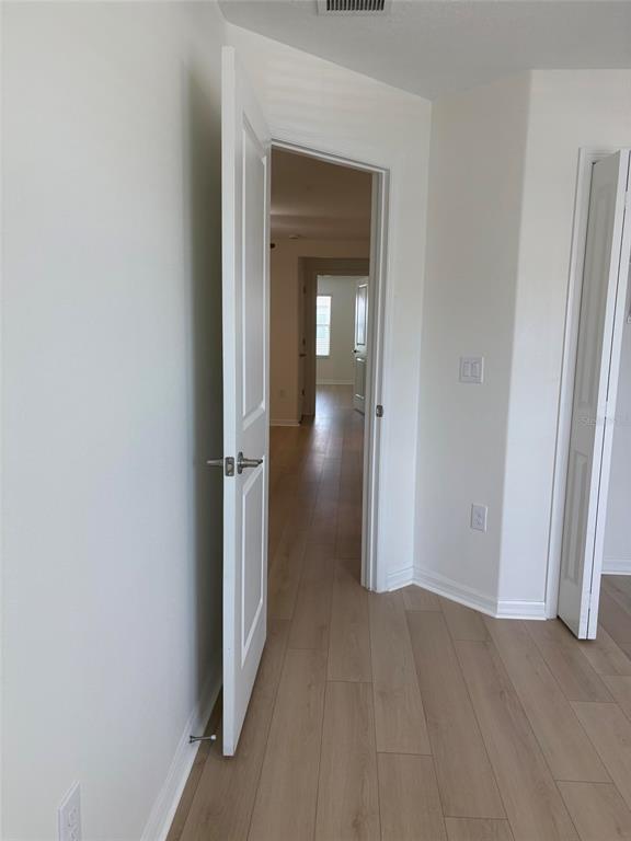 14442 Editors Note Street Ruskin, FL 33573 - Photo 8 of 31 a view of a hallway with wooden floor