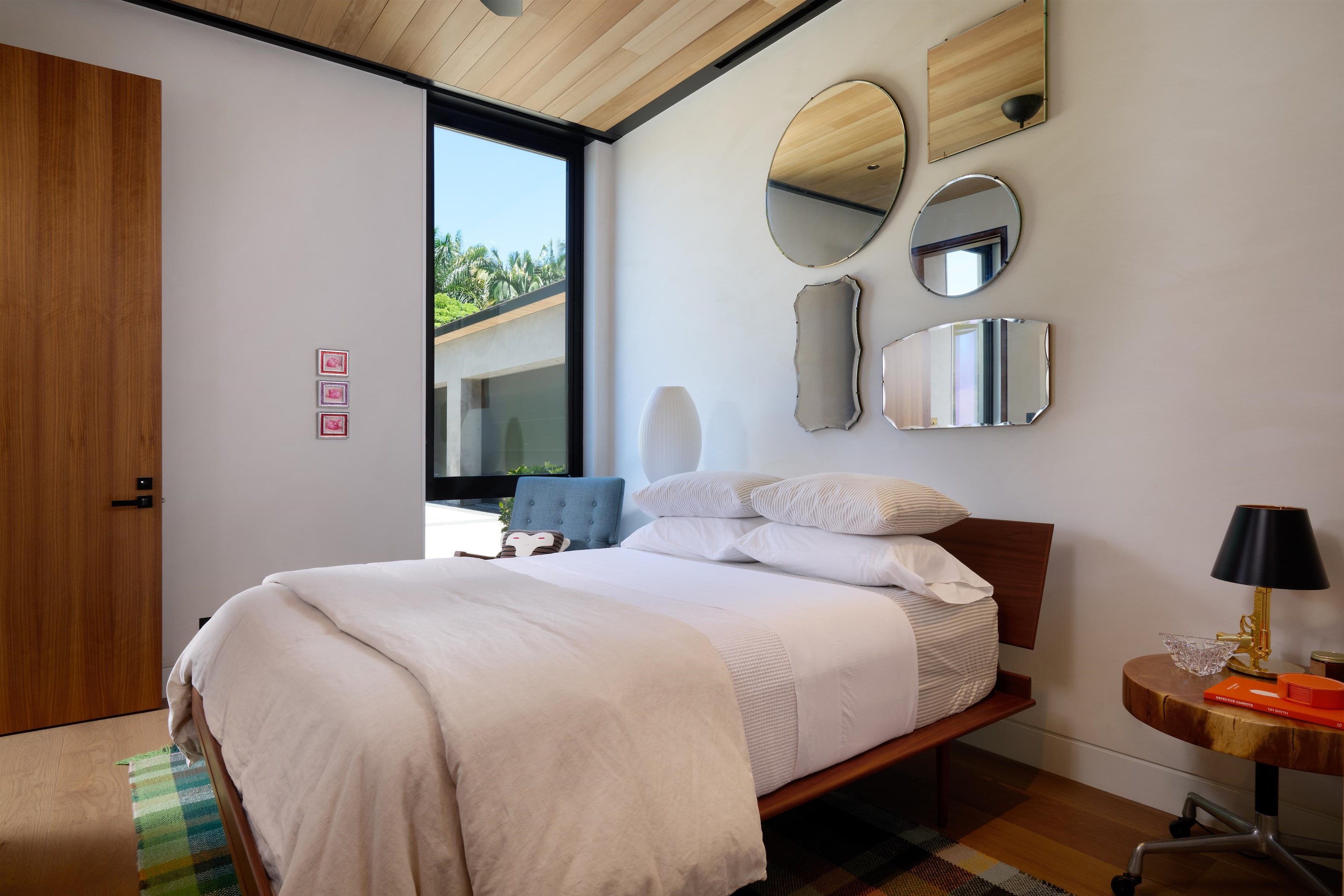 1642 West Kuiaha Road Haiku, HI 96708 - Photo 18 of 50 a bedroom with a bed and a lamp on dresser next to a window