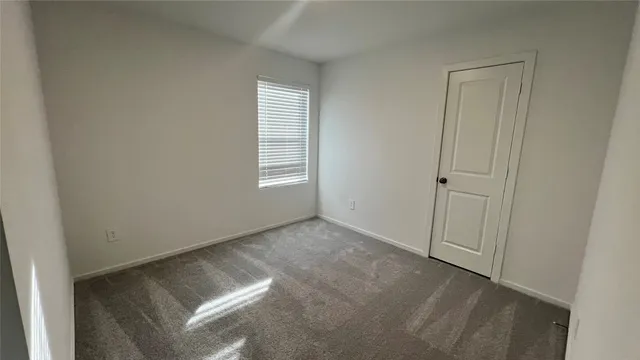a view of an empty room and a window