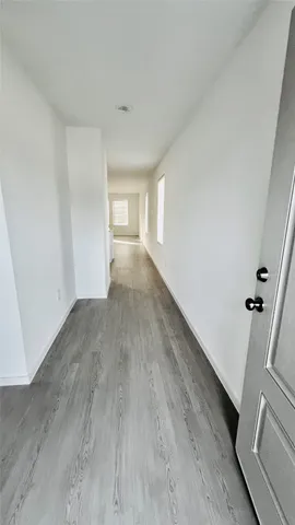 a view of a room with wooden floors and stairs