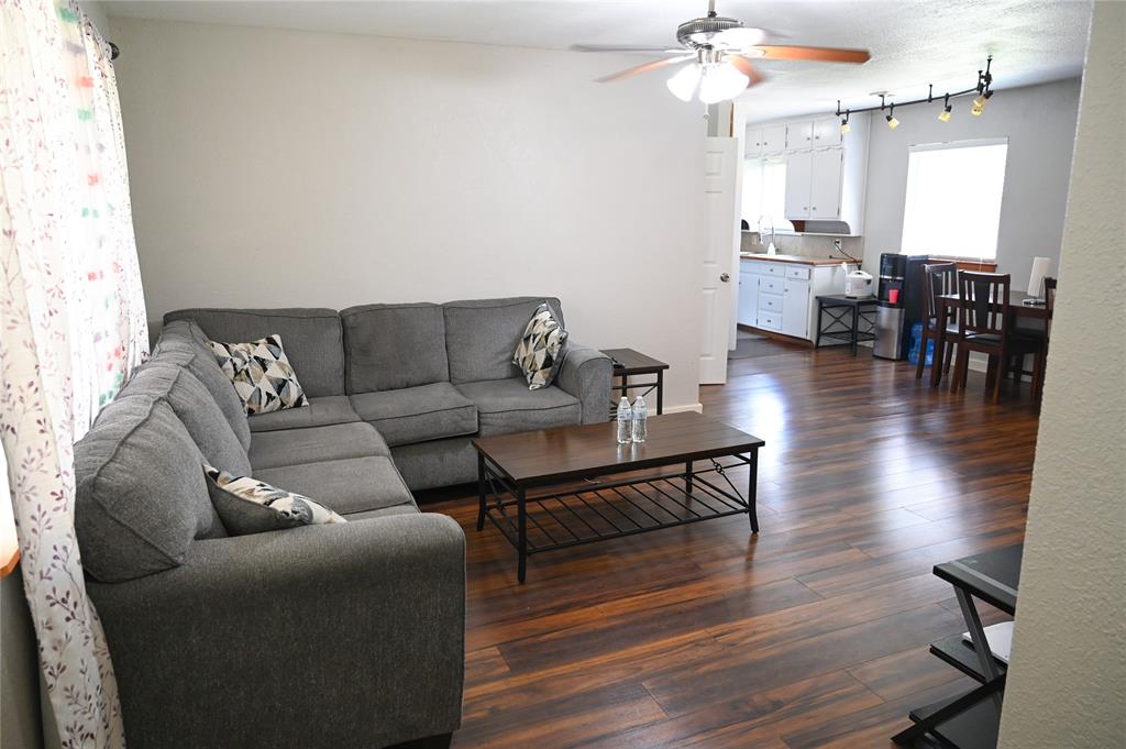 1352 Simpson Drive Hurst, TX 76053 - Photo 36 of 40 Spacious living area featuring wood-finish flooring, a ceiling fan, and track lighting