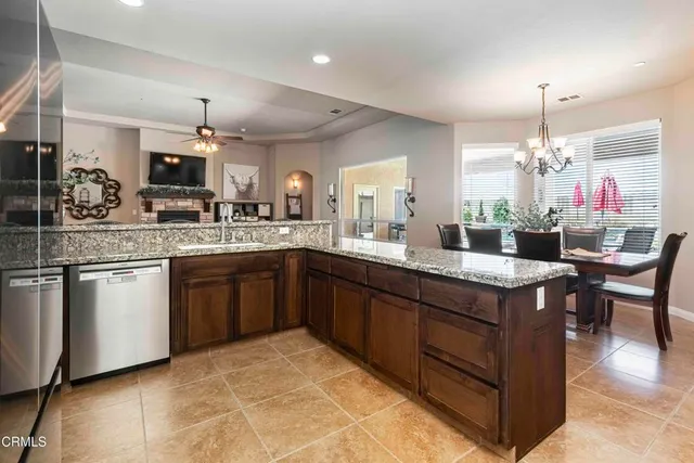 a kitchen with stainless steel appliances granite countertop a sink and a stove