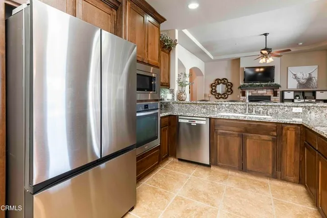 a kitchen with stainless steel appliances granite countertop a sink and a stove