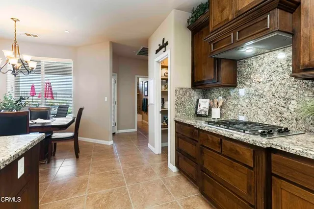 a large kitchen with kitchen island a large counter space and stainless steel appliances