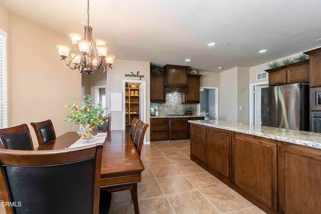 a spacious bathroom with a granite countertop sink and a mirror