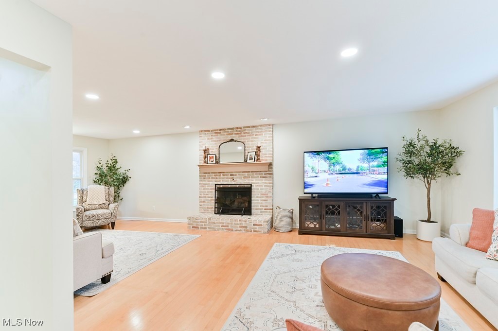 482 Longspur Road Highland Heights, OH 44143 - Photo 8 of 47 Living room featuring baseboards, wood finished floors, recessed lighting, and a brick fireplace