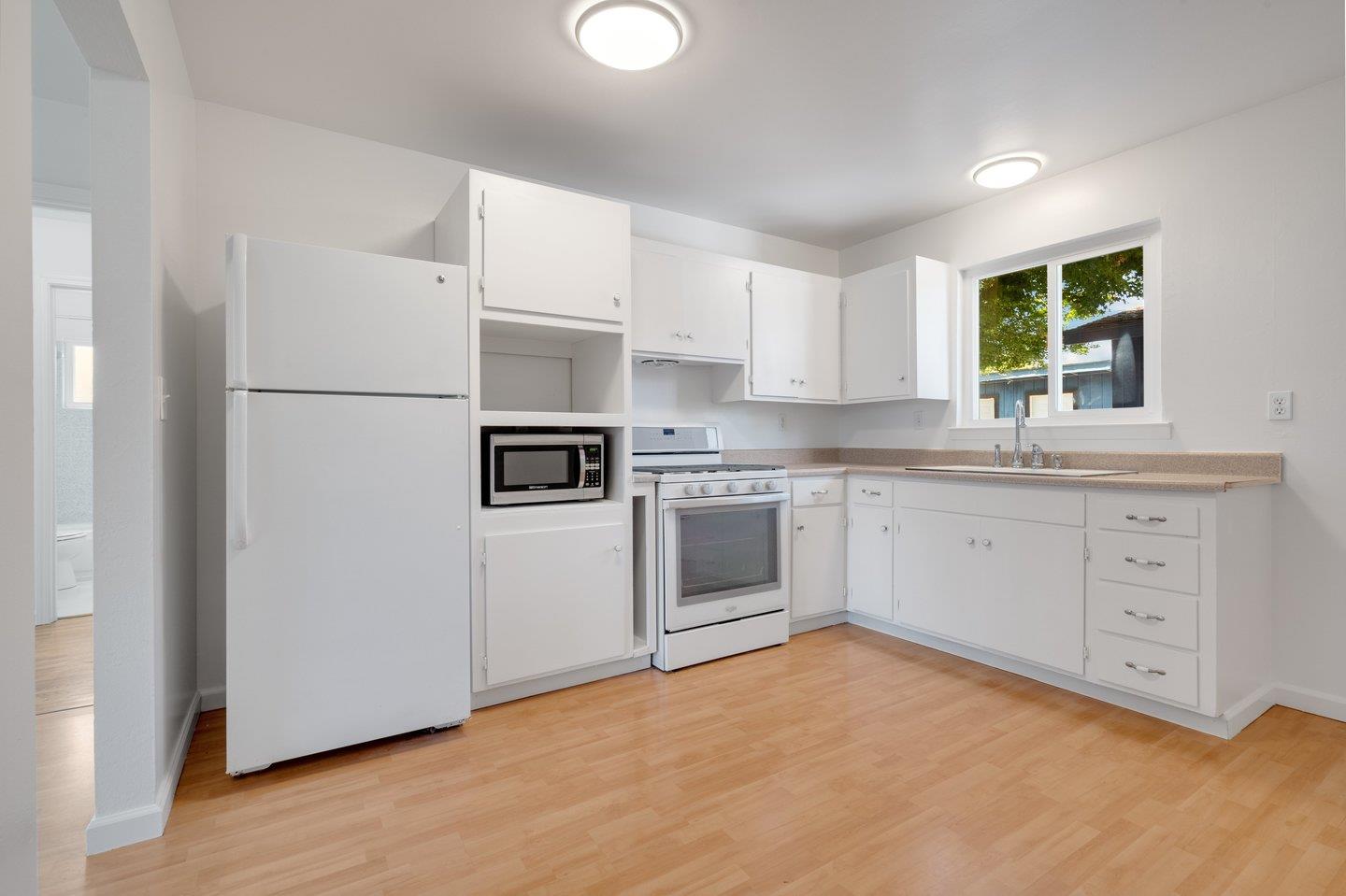 1107 Bismarck Drive Campbell, CA 95008 - Photo 16 of 21 a kitchen with white cabinets and white appliances