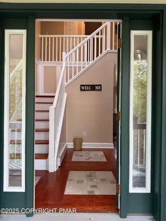 a view of a room with wooden floor and bathroom