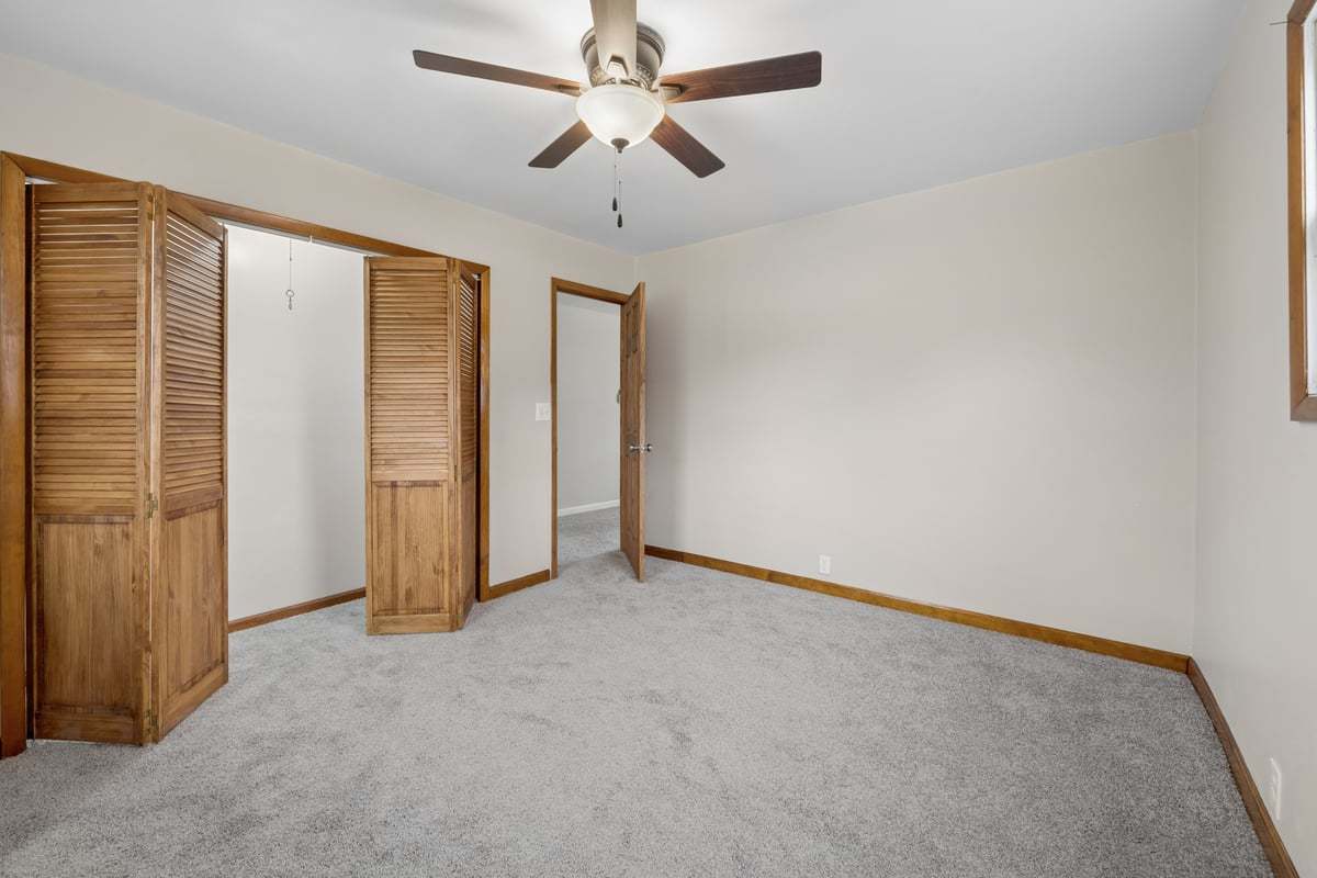 59 Wren Road Carpentersville, IL 60110 - Photo 13 of 19 an empty room with closet and a ceiling fan
