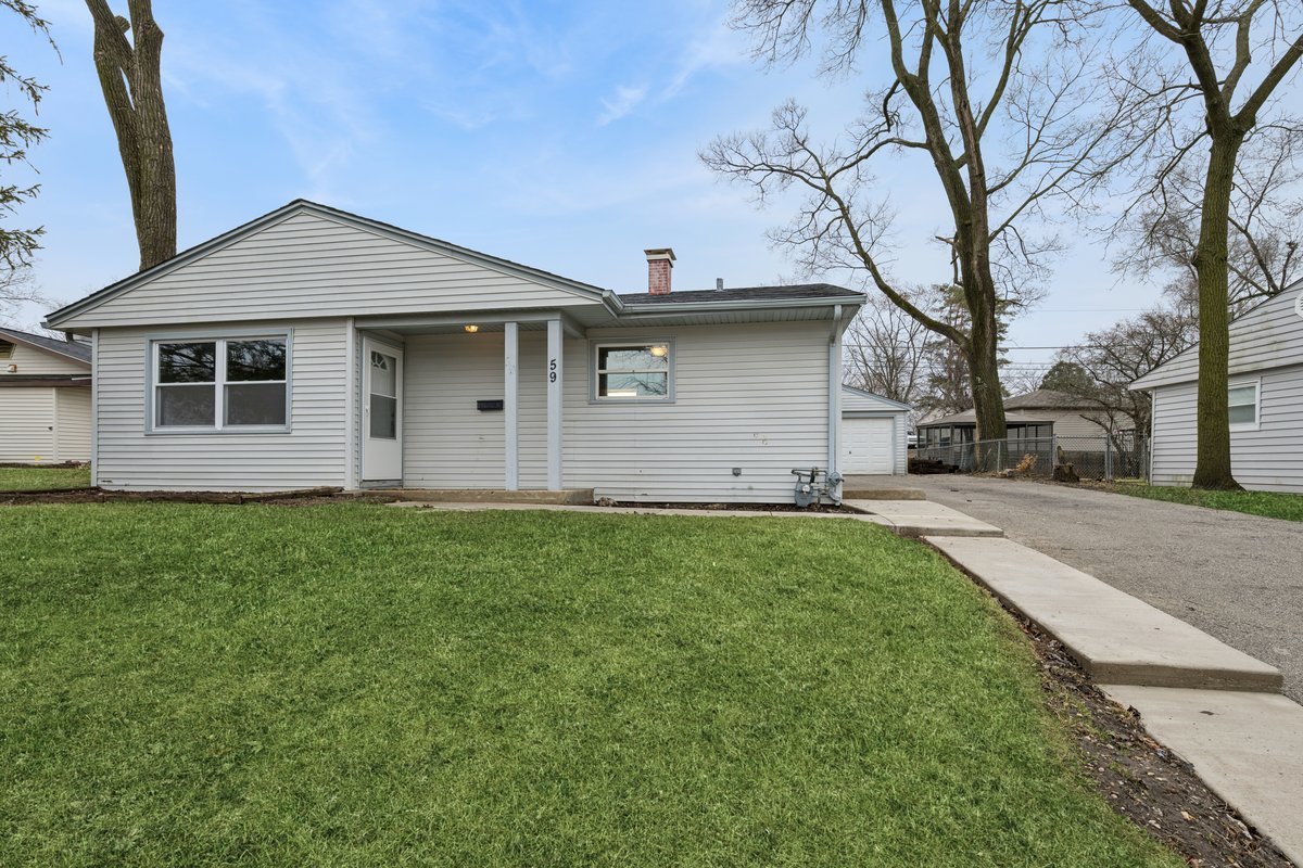 59 Wren Road Carpentersville, IL 60110 - Photo 2 of 19 a front view of house with yard and green space