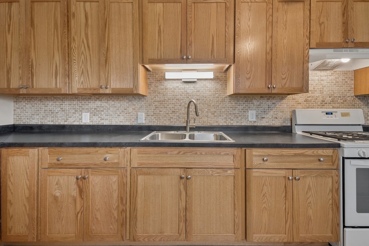 59 Wren Road Carpentersville, IL 60110 - Photo 6 of 19 a kitchen with white cabinets and white appliances