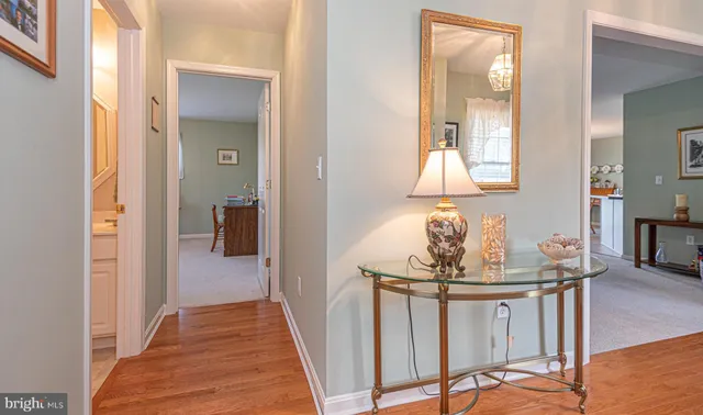 a view of a hallway to a livingroom and a dining room with furniture