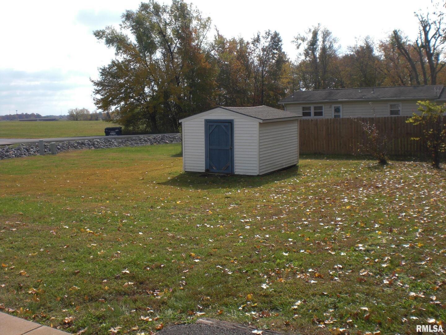 1109 Marion Street Carterville, IL 62918 - Photo 12 of 16 a view of a field with a tree in the background