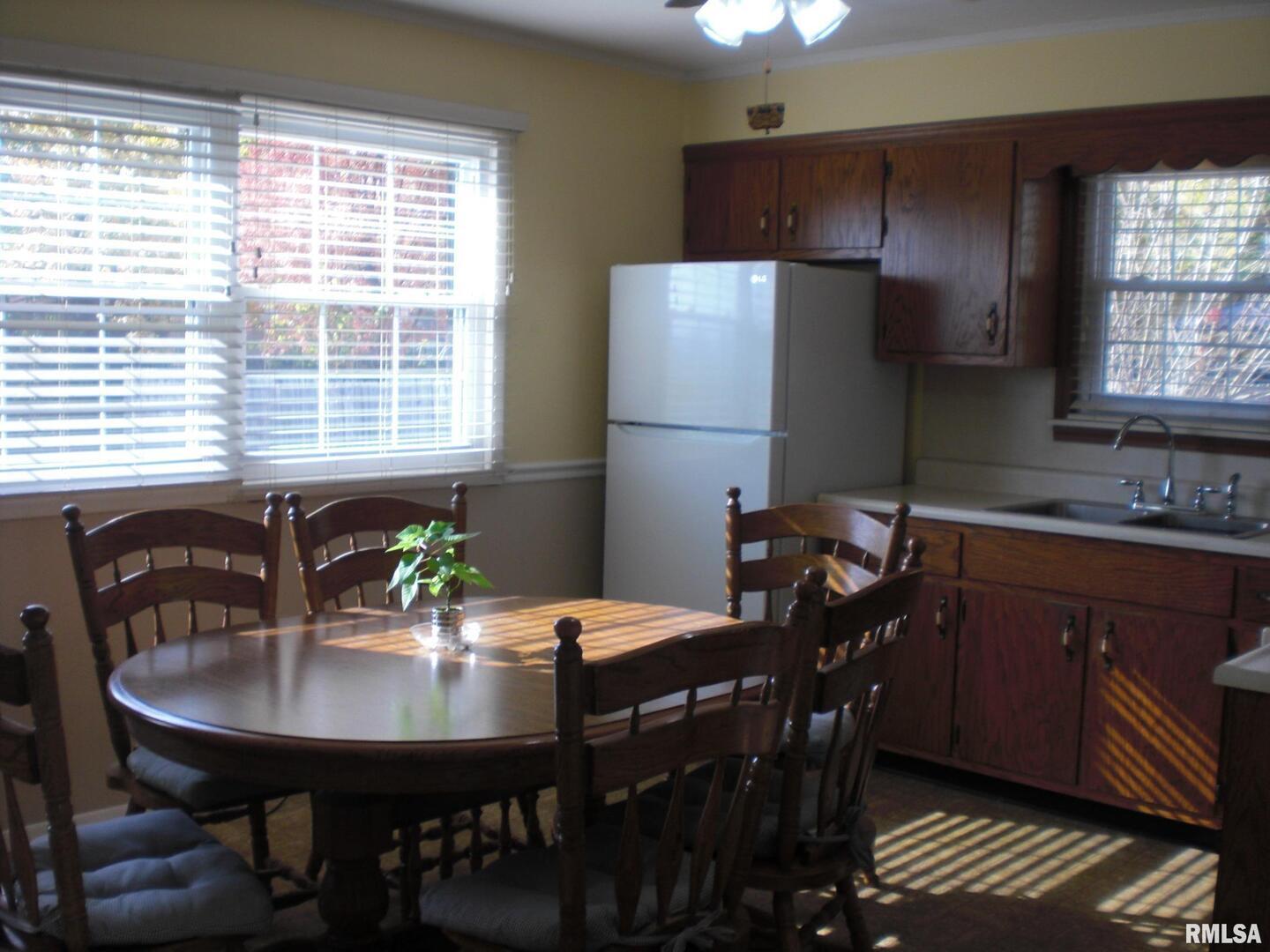 1109 Marion Street Carterville, IL 62918 - Photo 2 of 16 a view of a dining room with furniture and window