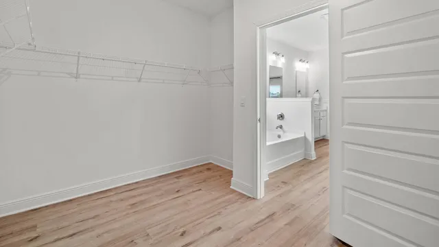 a bathroom with a bathtub a sink a mirror and a shower