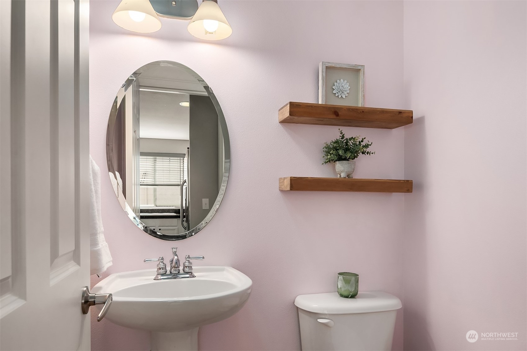 8517 Interlake Avenue North, Unit A Seattle, WA 98103 - Photo 11 of 20 a bathroom with a toilet a sink and mirror