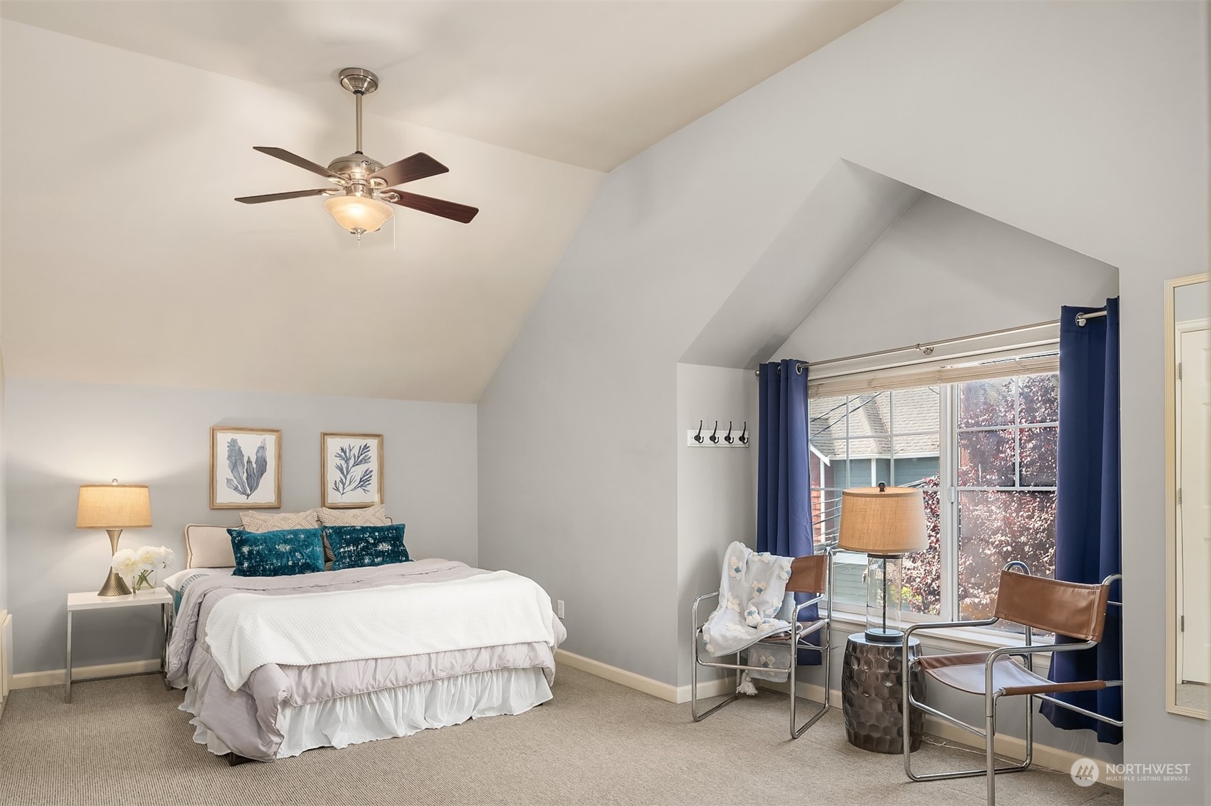 8517 Interlake Avenue North, Unit A Seattle, WA 98103 - Photo 12 of 20 a bedroom with a bed and a chandelier