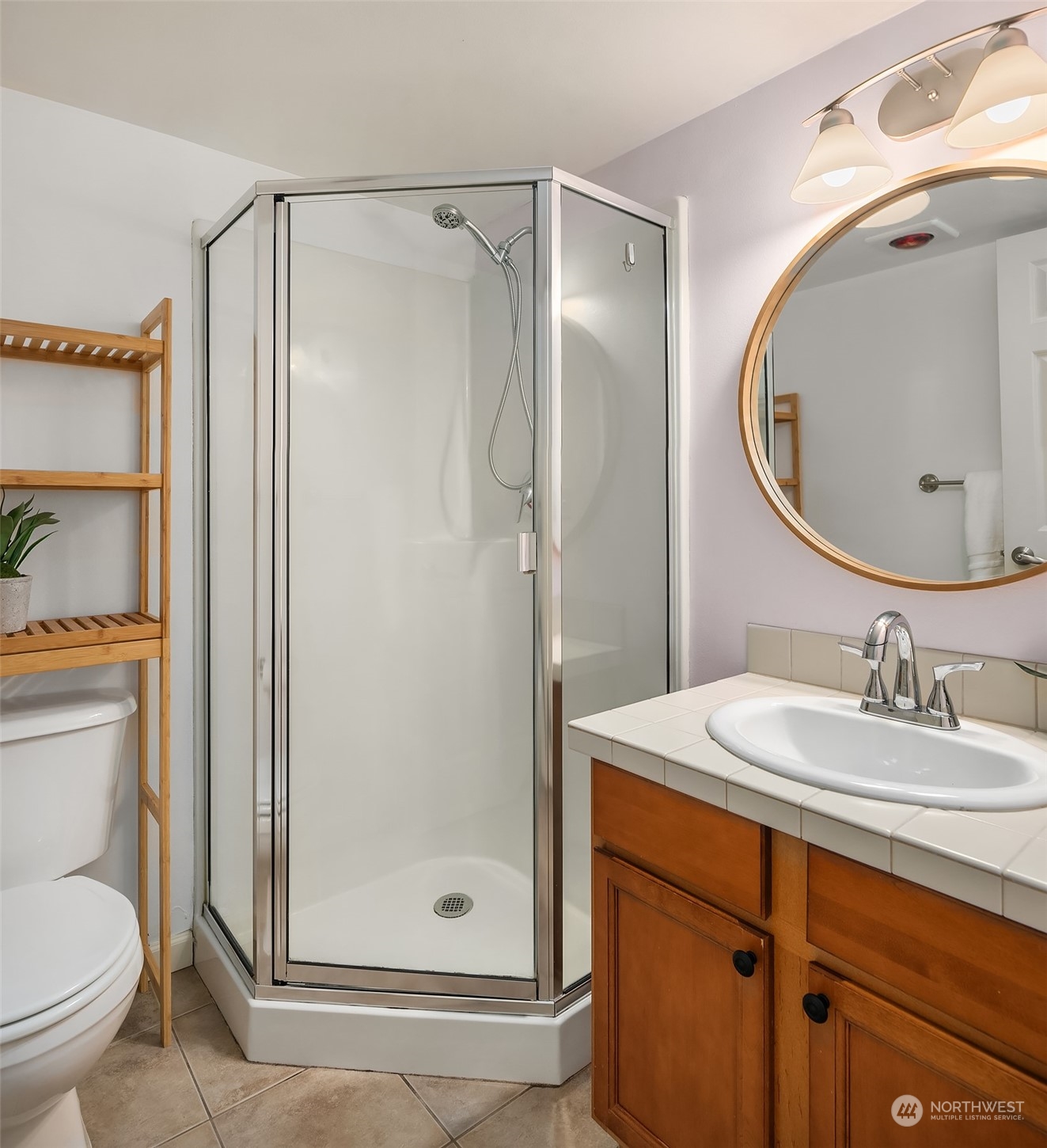 8517 Interlake Avenue North, Unit A Seattle, WA 98103 - Photo 15 of 20 a bathroom with a granite countertop sink toilet and shower