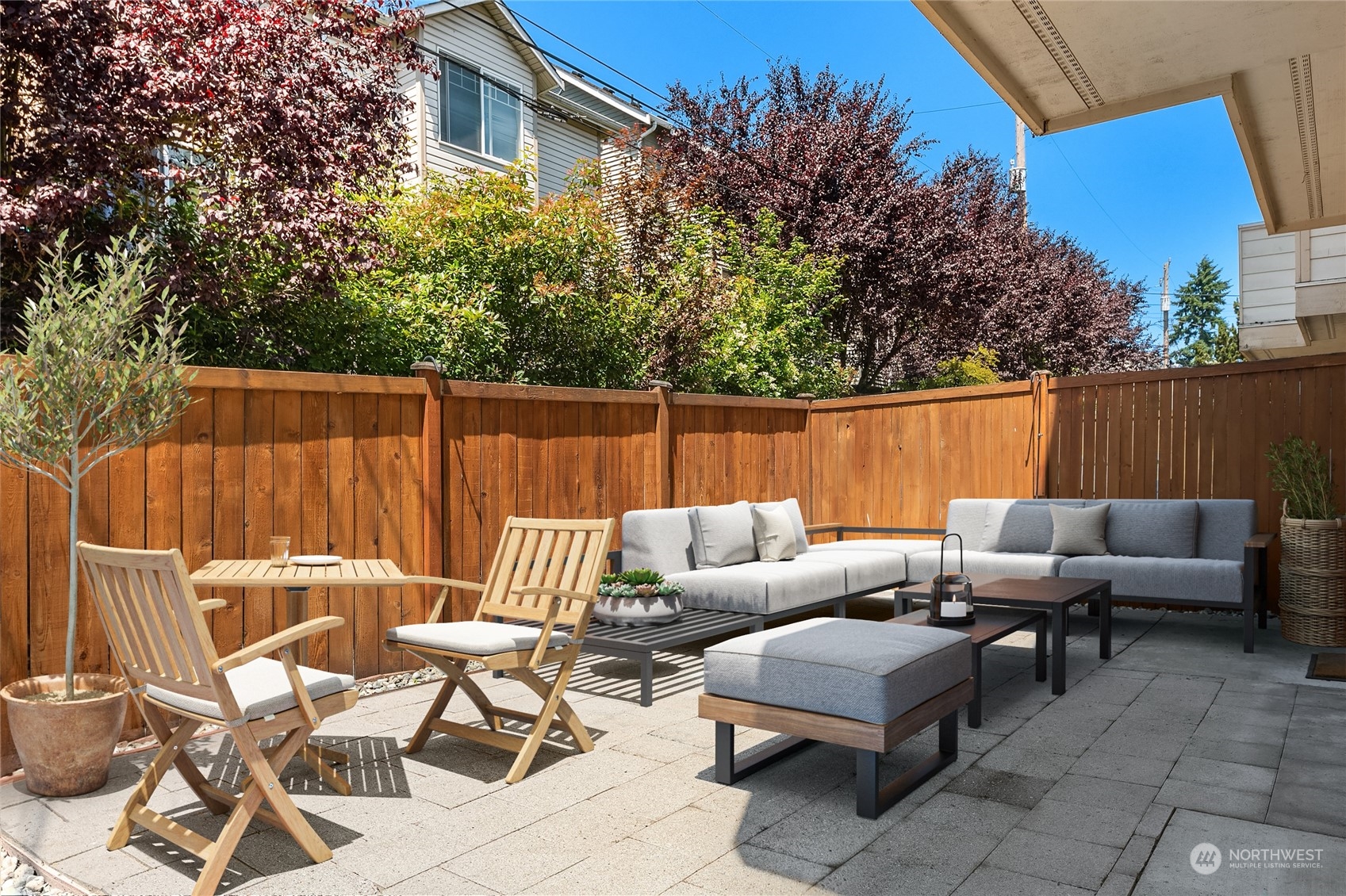 8517 Interlake Avenue North, Unit A Seattle, WA 98103 - Photo 19 of 20 a backyard of a house with table and chairs