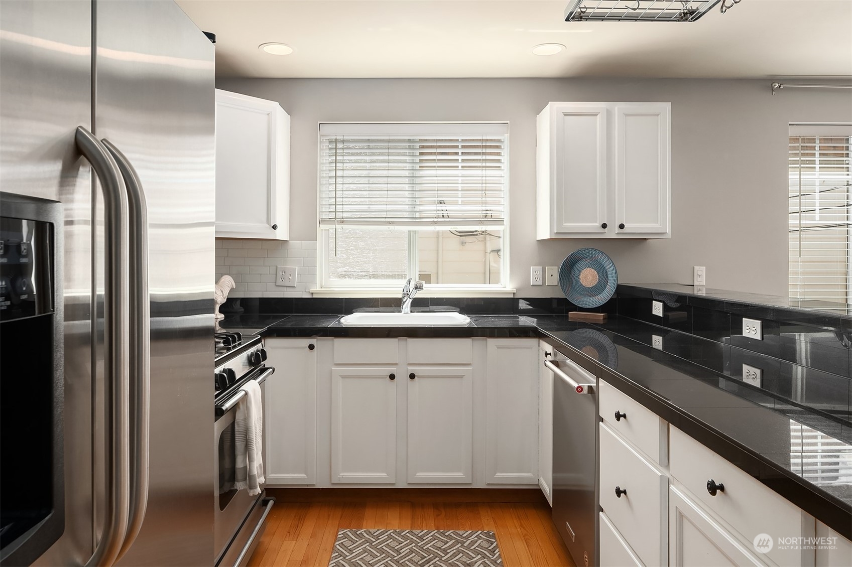 8517 Interlake Avenue North, Unit A Seattle, WA 98103 - Photo 9 of 20 a kitchen with a sink stove and refrigerator