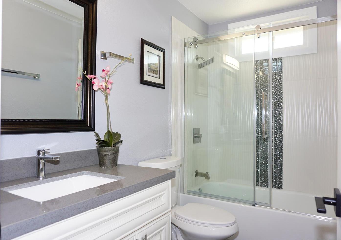 Kings Place Gilroy, CA 95020 - Photo 14 of 37 a bathroom with a granite countertop sink toilet a mirror a vanity and shower