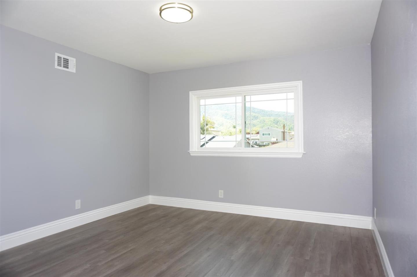 Kings Place Gilroy, CA 95020 - Photo 18 of 37 an empty room with wooden floor and windows