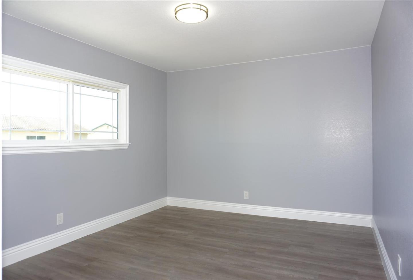 Kings Place Gilroy, CA 95020 - Photo 19 of 37 a view of an empty room with wooden floor and a window