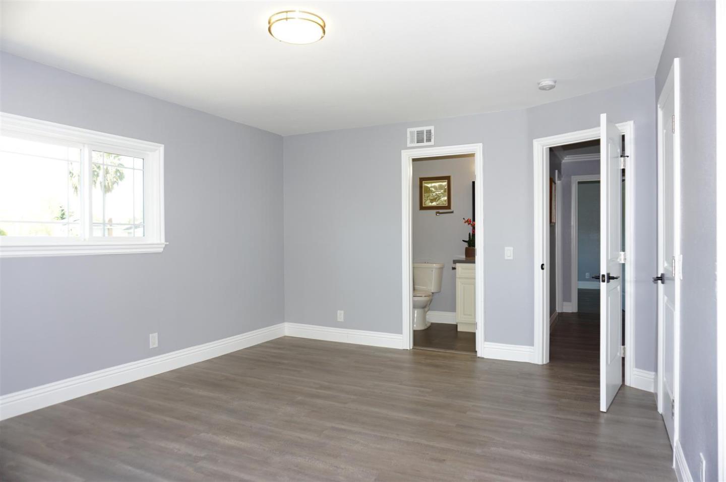 Kings Place Gilroy, CA 95020 - Photo 30 of 37 an empty room with wooden floor and windows