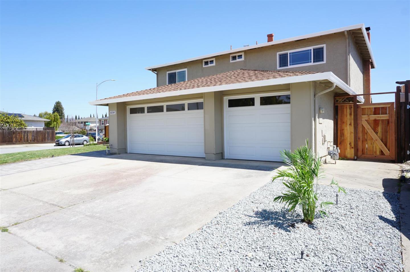 Kings Place Gilroy, CA 95020 - Photo 3 of 37 a front view of a house with a yard and garage