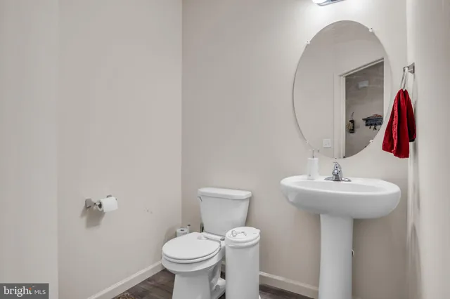 a bathroom with a sink mirror and toilet