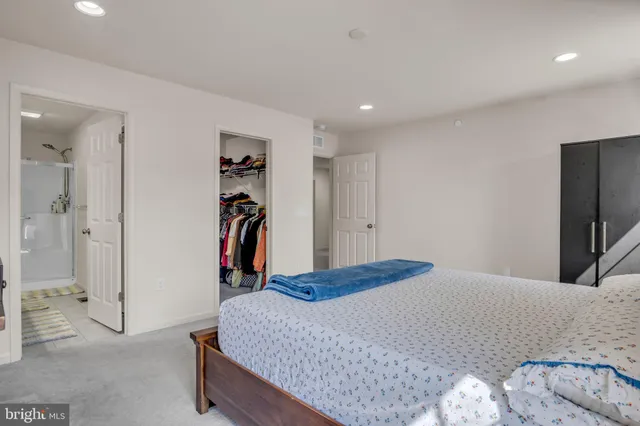 a bedroom with a bed and a walk in closet