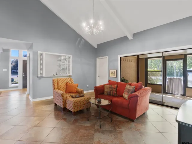 a living room with furniture and a chandelier