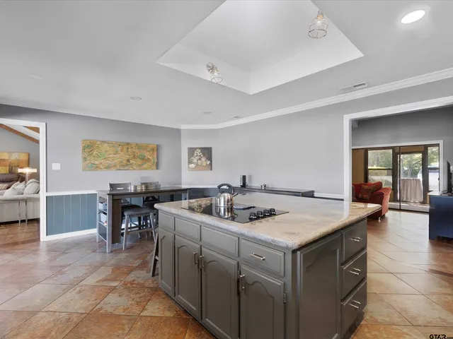a kitchen with a stove a table and chairs in it