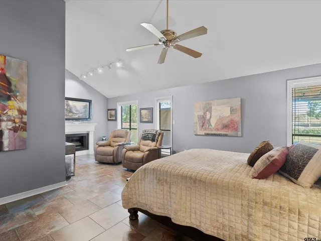 a bedroom with a large bed and a window