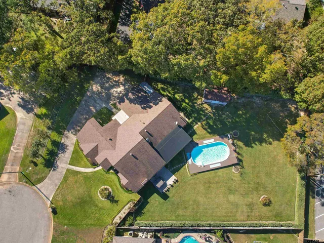 an aerial view of a house with a yard