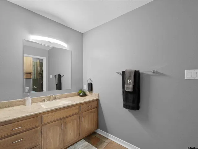 a bathroom with a double vanity sink and mirror