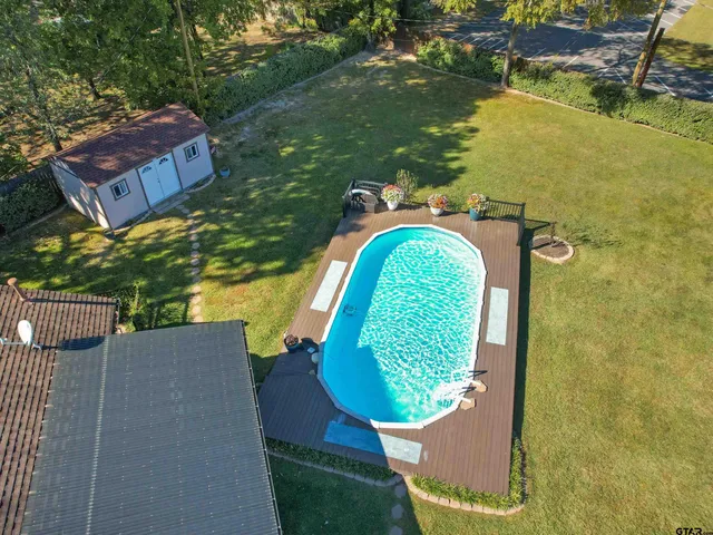 a view of roof deck with outdoor seating and yard