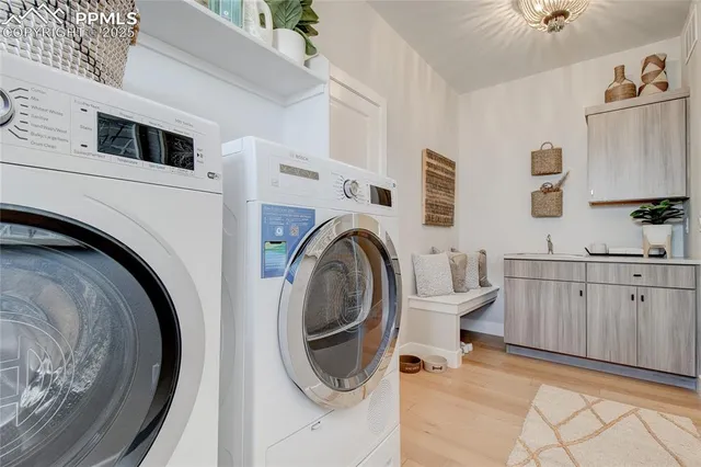 a view of a kitchen with sink washer and dryer