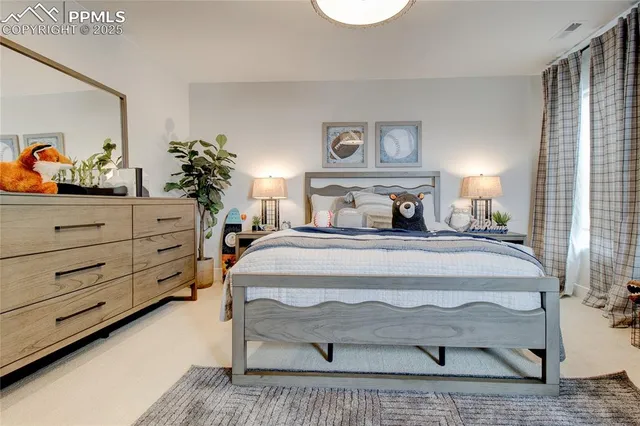 a bedroom with a bed and a potted plant on the dresser