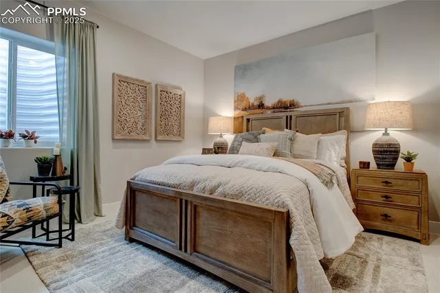 a bedroom with a bed and a tv on the dresser