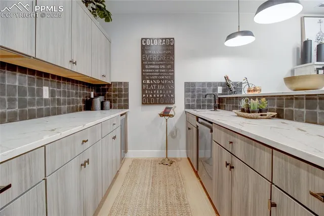 a kitchen with white cabinets and sink