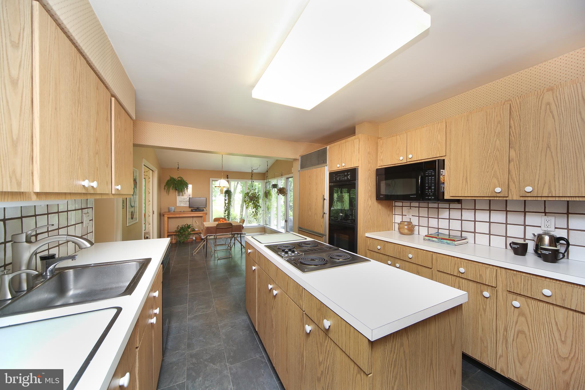 459 Wingate Road Huntingdon Valley, PA 19006 - Photo 16 of 31 a large kitchen with kitchen island a large counter top space a sink stainless steel appliances and cabinets