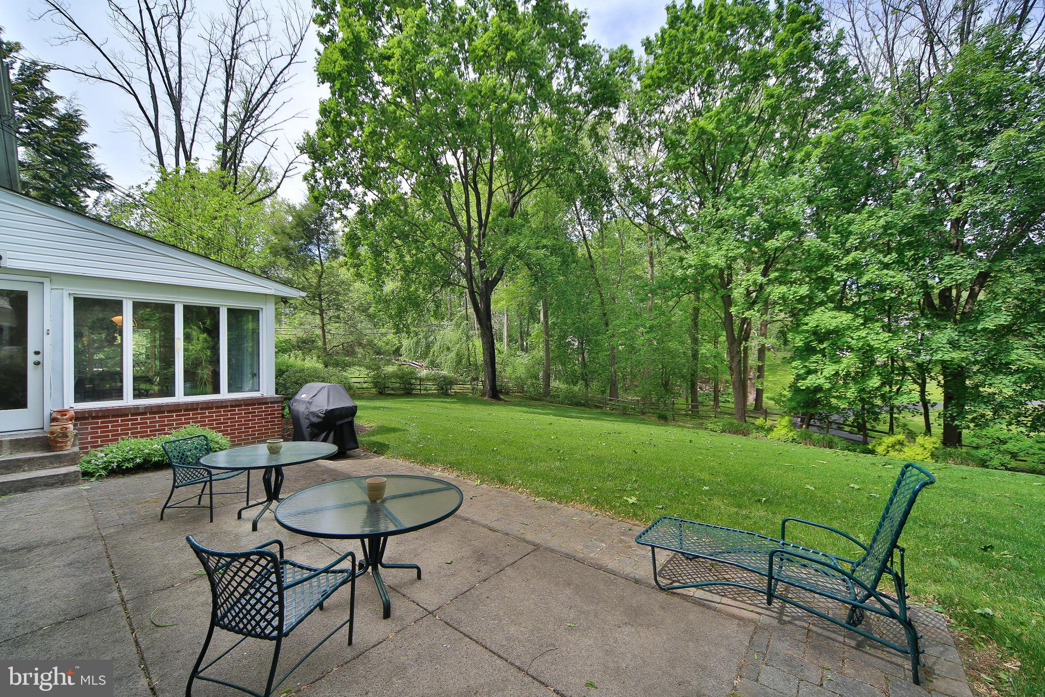 459 Wingate Road Huntingdon Valley, PA 19006 - Photo 30 of 31 a view of a backyard with table and chairs with wooden fence and plants