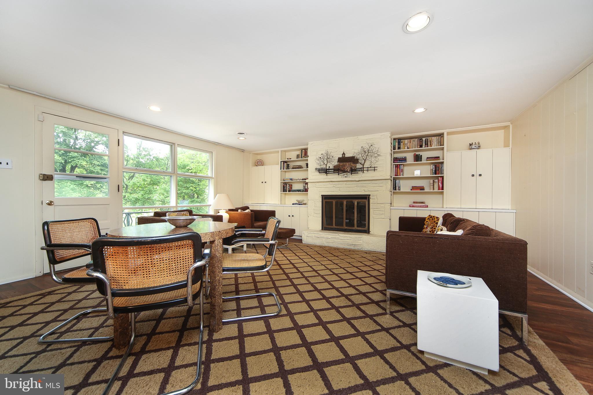 459 Wingate Road Huntingdon Valley, PA 19006 - Photo 6 of 31 a living room with furniture a fireplace and a large window