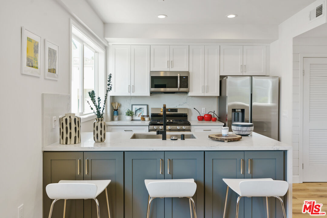 14652 West Sara Lane Panorama City, CA 91402 - Photo 12 of 33 a kitchen with a dining table and chairs