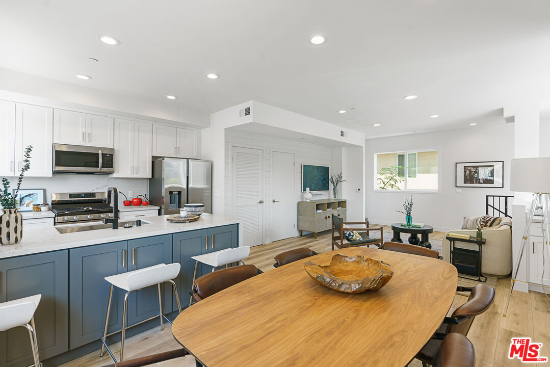 14652 West Sara Lane Panorama City, CA 91402 - Photo 13 of 33 a large kitchen with kitchen island a dining table and chairs